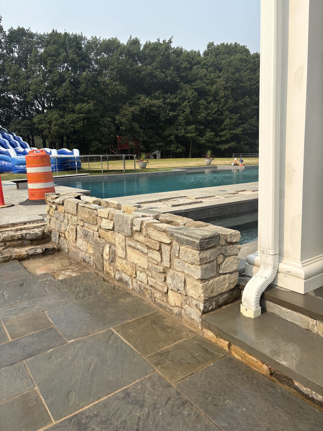 Stonework — Dry-laid stone pool wall and bluestone deck by MST Construction